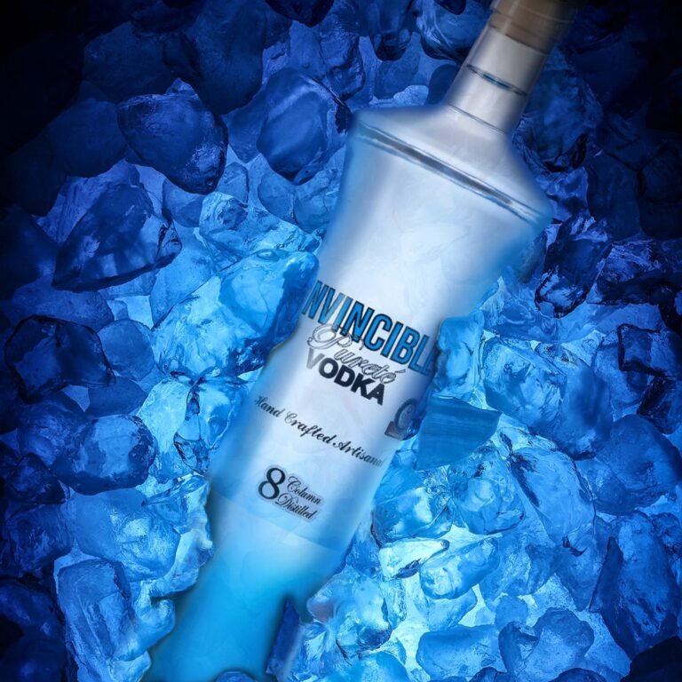 Invincible Vodka bottle resting on crushed blue ice, highlighting its perfectly chilled serving experience.