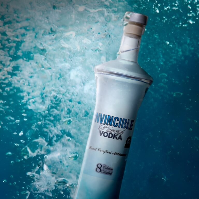 Premium Invincible Vodka bottle displayed against a blue icy background representing smooth vodka craftsmanship.