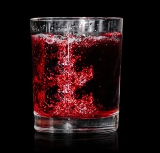 Cherry Caipiroska cocktail on glass surface